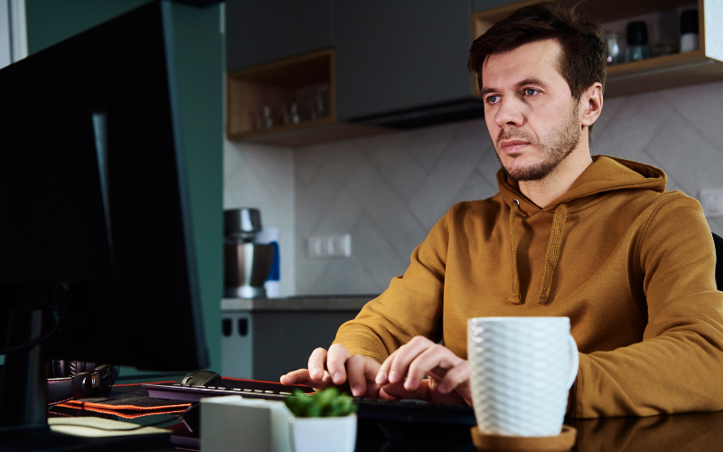 Hybrides Arbeiten eines jungen Mannes im Homeoffice